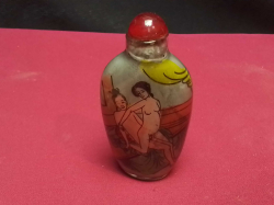 A Chinese glass perfume bottle decorated with erotic scenes
