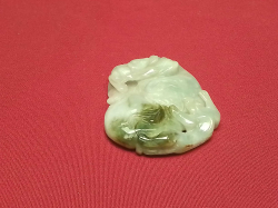 A carved green jade piece 5cm long