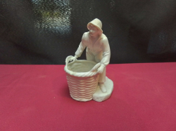 An 1890-1930 German bisque porcelain figurine of a boy with large basket (unmarked) 14cm high