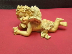 An antique piano baby winged cherub figurine 11cm long