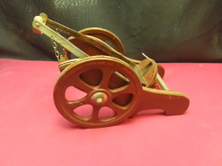 A brass and wood 'very old Napoleon brandy' cannon bottle holder 8inches high x 10 inches long