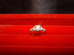 A hallmarked 18 carat white gold diamond engagement ring (weighs 1.7 grammes) missing one small stone
