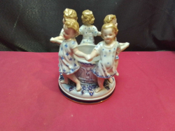 A stunning German porcelain centre piece - bowl surrounded by 5 dancing children (7 inches high x 6 inches wide) in perfect condition - marked underneath