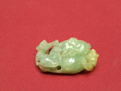 A heavily carved green jade piece 4.5cm long