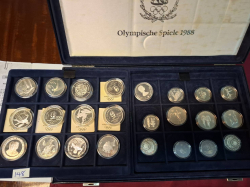 A boxed set of 61 Albertive oympic 0.90 silver coins each about 18 grams totall uncirculated 