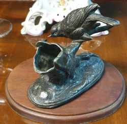 A Victorian C,1865 English pewter spill vase  decorated with bird catching insect. With oval mahogany stand W.16 H.12 Cm.