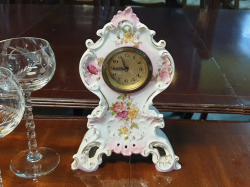 A beautiful  antique Victorian  German hand painted porcelain mantle Clock. With original wound up mechanism in working order. W.15 H.23 Cm.