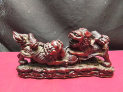 A Chinese statue of two foo dogs with babies riding on their backs. L.24 H.12 Cm.