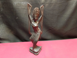 A wooden oriental hand carved wooden figure. H.28 Cm. 