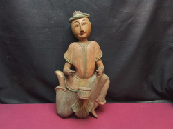 A Carved Seated Wooden Bhuma Musician Figure. W.22 H.42 Cm. 