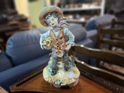 A Lovely vintage capodimonte Italian figurine with fruits & flowers of a young boy stamped to base ( a small crack on base)