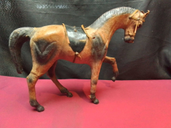 An Early 20th Century Wooden Horse with Leather Fittings. W.35 H.27 Cm.