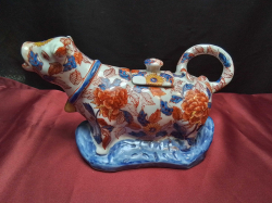 Chinese creamer in the shape of a bull 6 character mark to base. ( A  small A/F on lid). W.23 H.12 Cm.