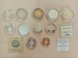 A collection of 11 vintage German silver proof coins/medals in protective cases