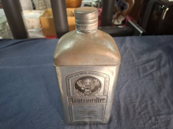 A Tin Jagermeister box with a bottle