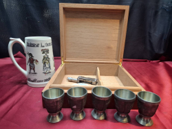 A wooden cigar humidifier with a mug and pewter egg cups