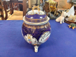 A Porcelain Flower Decorated Lided Vase on 3 Feed. W.18 H.14 Cm.