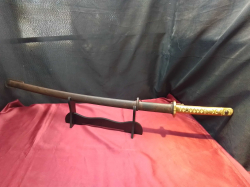 A samurai sword with the golden handle and stand. L.96 Cm. 