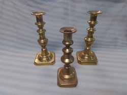 A Trio of Brass Candle Sticks Including A Pair H.19,21 