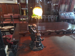 A Lovely Fibre Lamps of 2 Charubs  Playing a Horn and Mandolin with  A Multi Colored Art Glass Shade. W.18 H.49 Cm.