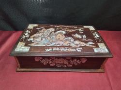 A vintage inlaid mother of pearl wooden box 25cm wide x 7cm high