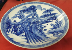 A beautiful large oriental blue and white charger decorated with mythical scenes mountains and clouds river etc.W.45 Cm.Estimate 2,000-3,000