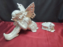 A Large Seated Angle Figure(1 part reglued) W.20 D.32 H.25 Cm. and A Small Angle Figure 