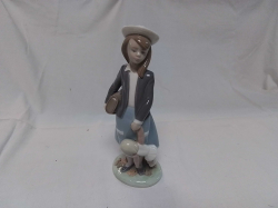 A Lovely LLADRO Figure of A Young School Girl Holding a Toy Doll.  (Minor A/F on hat) W.8 H.21 Cm.