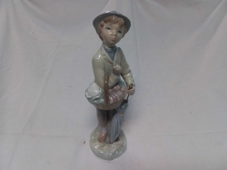 A Very Nice LLADRO Figure of a Boy with Basket and Umbrella. Finger A/F.  W.8 H.27 Cm.