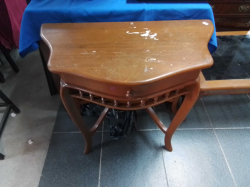 A Small Half Table With A Drawer.