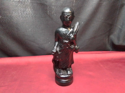 A Standing Black Monk. W.7 H.25 Cm.