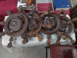 4 Ships Wheels containing Electric Clock. W.50 Cm.