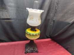 A Lovely Victorian Oil Lamp with Green Reservoir Cast Iron Base and   A Floral Shade. W.18 H.57 Cm.