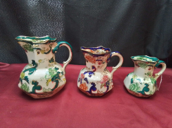A Set of 3 Masons Graduated Jugs with Serpent Handles.
