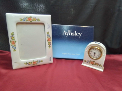 A Nice Aynsley Frame in an  original Box. W.19 L.24 Cm.and A Clock H.13 Cm.