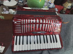 Vintage as new large red Yamaha accordion in leather case. 