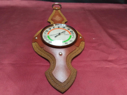 A vintage thermometer in leather case. W.15 H.40 Cm.