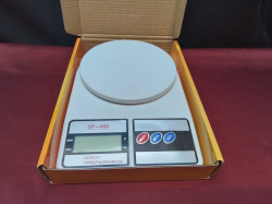 An electric kitchen scale new with battery.