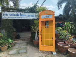 A Yellow Replica Metal Phone Box with light.