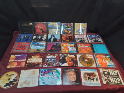 A collection of UK pop music CDs including ABBA GOLD