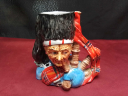 A large vintage 'Scottish Bagpipes' character jug, 6 inches high 