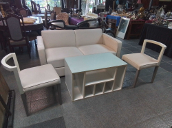 A White 2 Seater Sofa with top Glass Table and 2 Chairs.