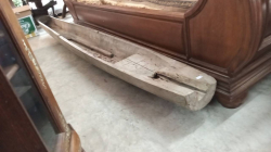 A Wooden Boat and A paddle.