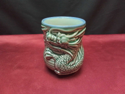 A Chinese cup showing a dragon 11 cm. tall 8cm diameter