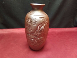 A Chinese vase showing a foo dog Signed to the front of the vase 22cm tall 