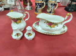 A Royal Albert Old Country Roses Gravy Bat and Stand , A Cream Jug, A Salt& A Peper.(4 pieces)