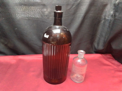 A Large Brown Glass Medical Jar. W.13 H.35 Cm. And 1 Small Jar.