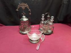 A Silver Plated Antique Cruet Set With Crystal Bottles, Lovely Etched Glass Divided Serving Bowl With Glass Serving Spoon and Sterling Silver Base and  An antique silver plated pickle jar, on stand with tongs .H.29 Cm.