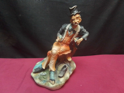 A Capodimonte Figure of A Seated Tramp. W.17 H.25 Cm.
