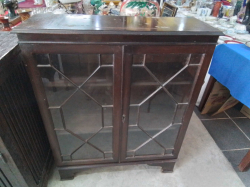 A Small Glazed Bookcase Standing on Bracket Feet. W.90 D.30 H.110 Cm.